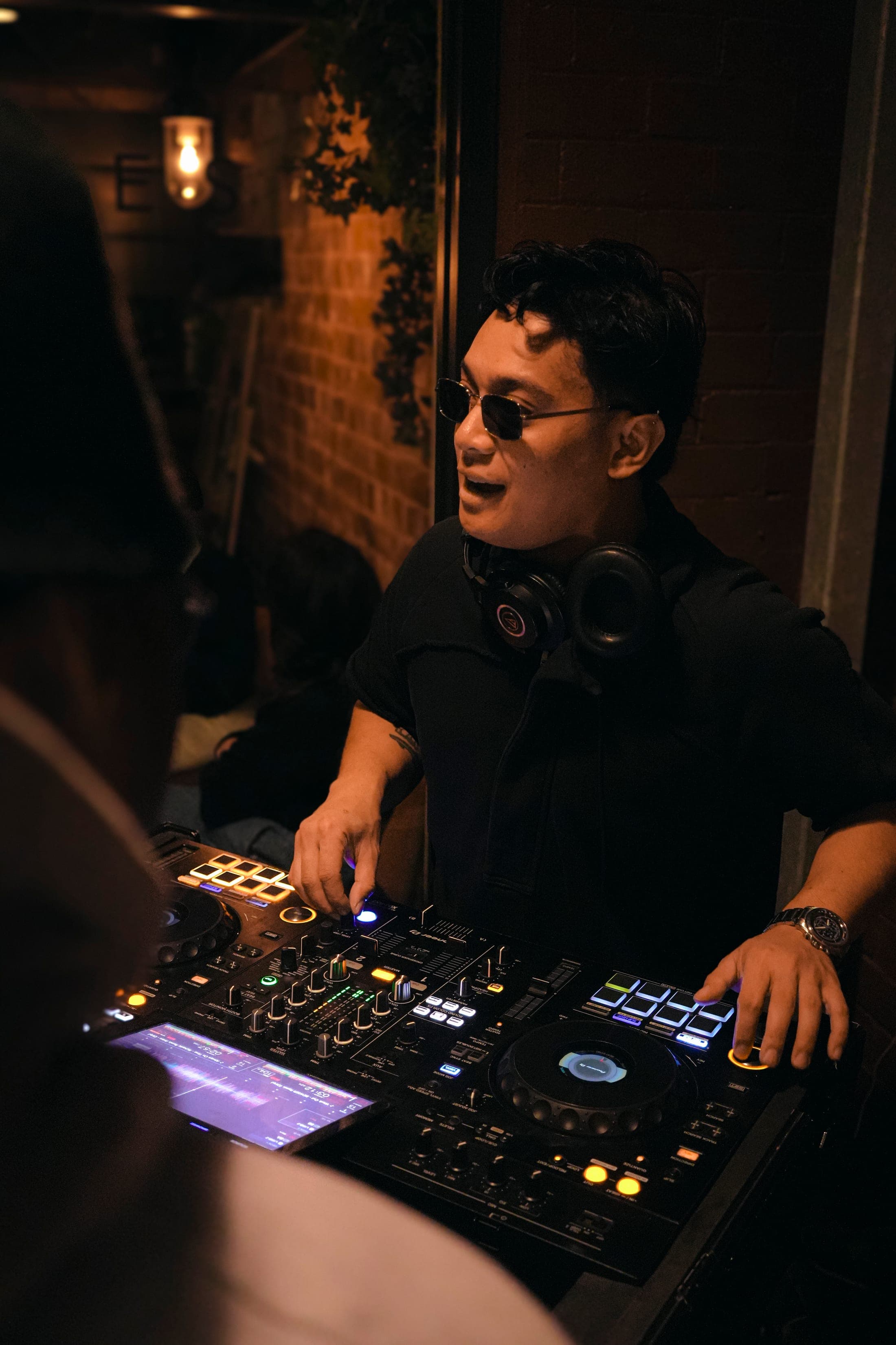 Sikuya performing behind the decks with the crowd close to the booth